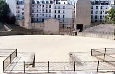 One side of arena obscured by buildings on rue Monge.