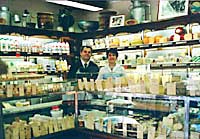 Proprietor William Jouannault in front of cheese display at Fromagers de France